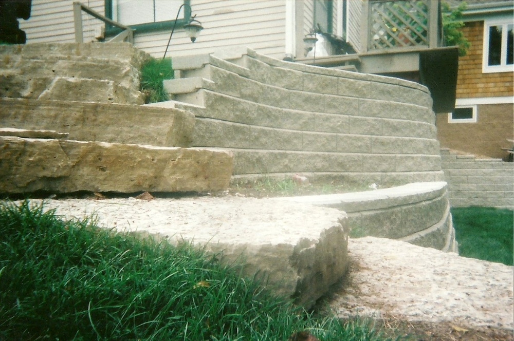 High retaining wall and stone path add to yard space
